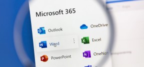 Das Bild zeigt die Microsoft 356 App Icons auf einem Desktop geöffnet unter einer Lupe.