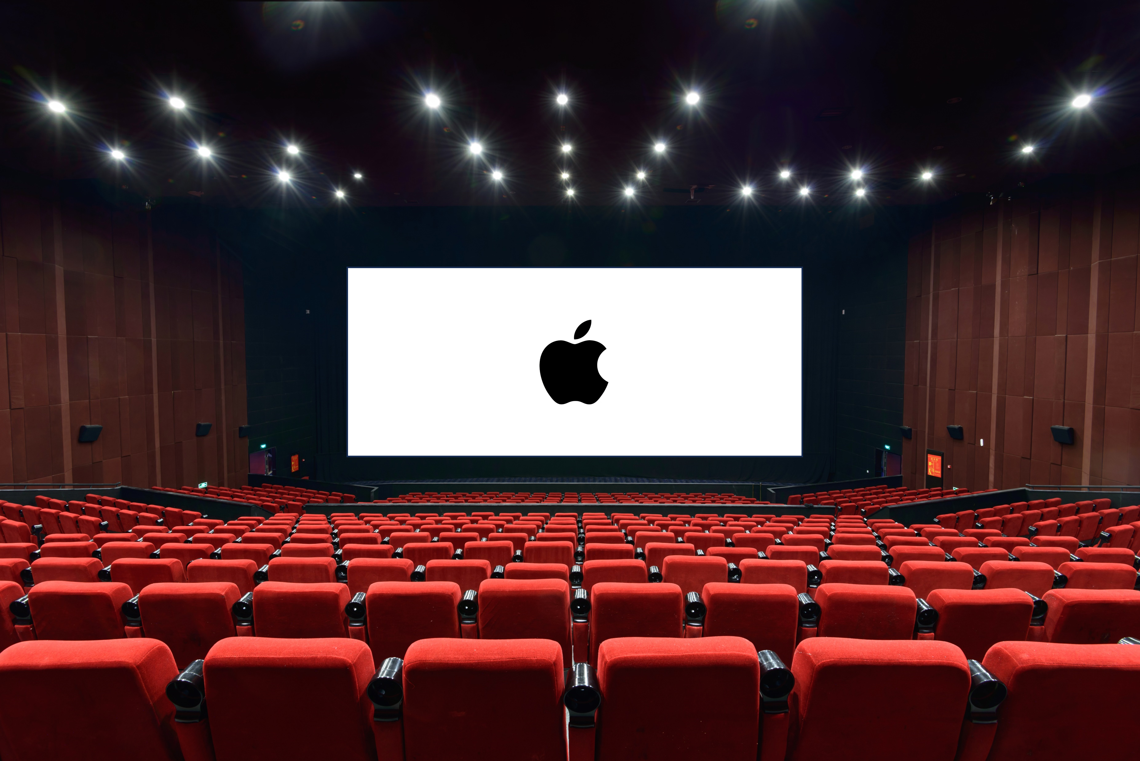 Auf dem Bild ist das Apple Logo auf eine Kinoleinwand prpjiziert zu sehen.